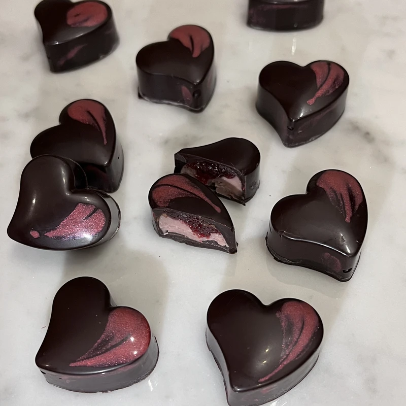 Raspberry ruby chocolate hearts with visible fruit pieces